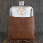 1949 Australian half penny with kangaroo design set into a polished pewter hip flask in a brown leather sleeve