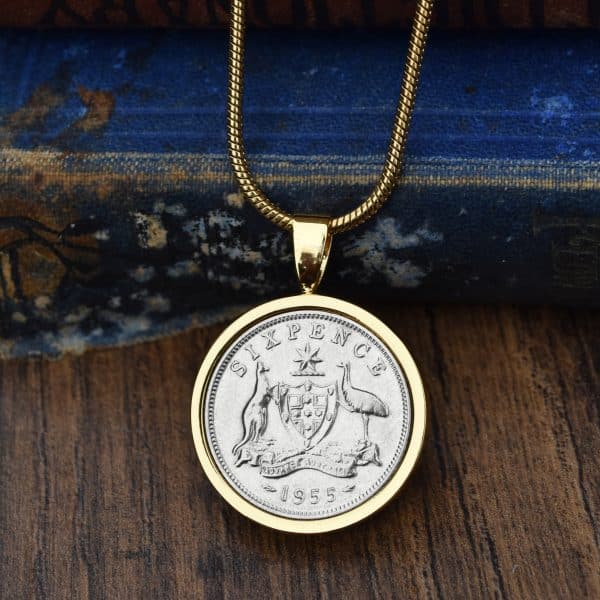 1955 Australian sixpence in a gold bezel pendant on a gold chain, kangaroo and emu coat of arms