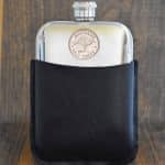 1956 Australian half penny with kangaroo design set into a polished pewter hip flask in a black leather sleeve