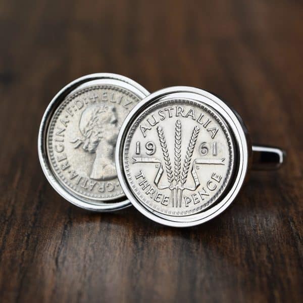 Pair of 1961 Australian threepence cufflinks in silver bezels, wheat-ears reverse facing out, on dark wood