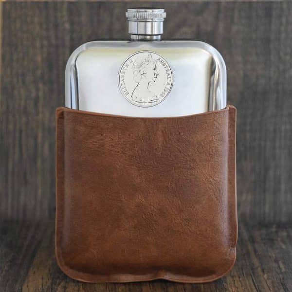 1968 Australian 20 cent coin set into the front of a polished pewter hip flask in a brown leather sleeve
