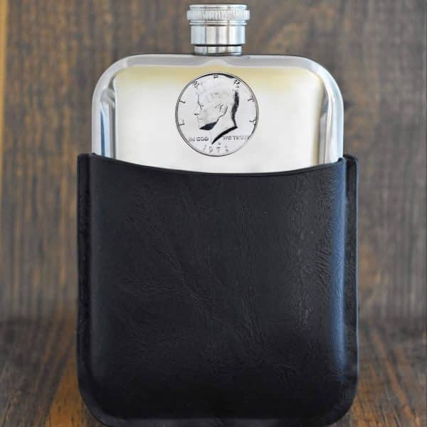 1972 United States half dollar with Kennedy portrait set into a pewter hip flask in a black leather sleeve