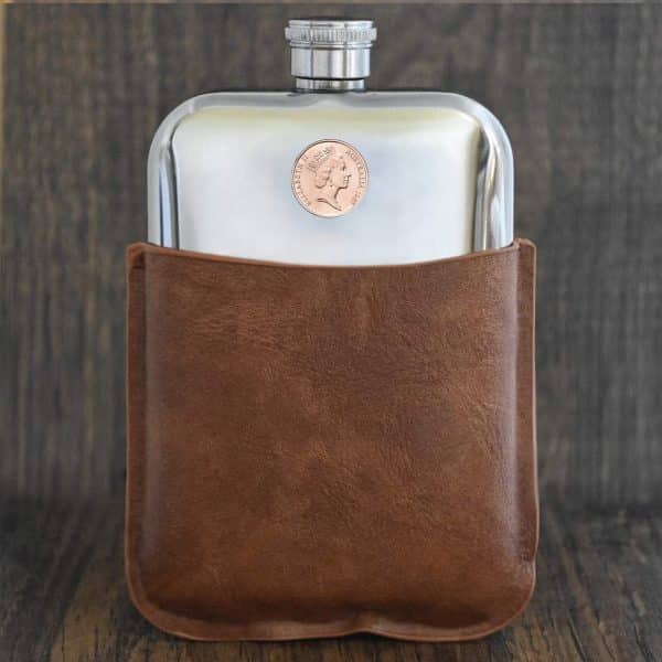 1987 Australian coin with Elizabeth II portrait set into a polished pewter hip flask in a brown leather sleeve
