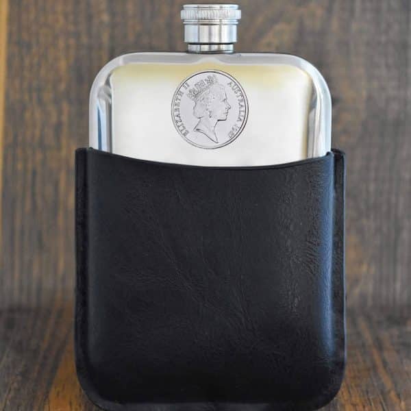 1987 Australian 20 cent coin set into the front of a polished pewter hip flask in a black leather sleeve