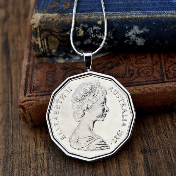Twelve-sided Australian coin dated 1987 in a silver-tone pendant bezel on a snake chain, Elizabeth II obverse