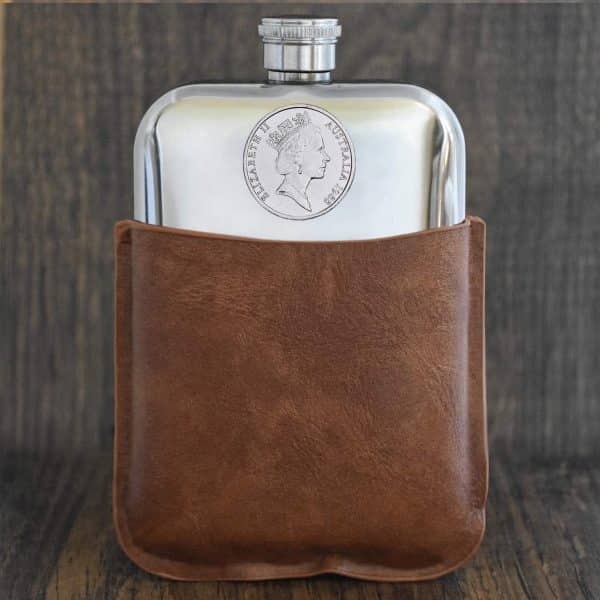 1988 Australian coin with Queen Elizabeth II portrait set into a polished pewter hip flask in a tan brown leather sleeve