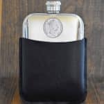 1998 Australian coin with Queen Elizabeth II portrait set into a polished pewter hip flask in a black leather sleeve
