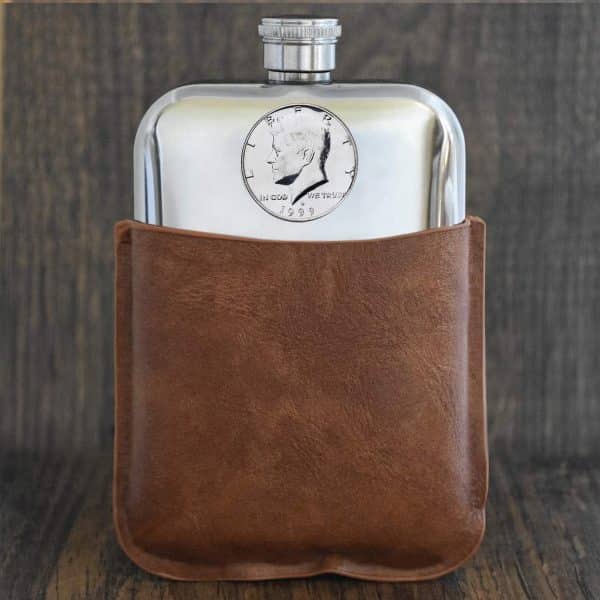 1999 United States half dollar with Kennedy portrait set into a pewter hip flask in a brown leather sleeve