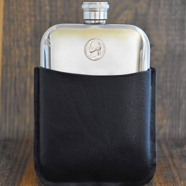 American Jefferson nickel set into the front of a polished pewter hip flask in a black leather sleeve