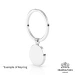 Blank back of a round silver bezel keyring hanging from its split ring, white background