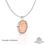 1987 Australian coin in a silver bezel pendant on a snake chain, angled to show the rim
