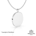 Back of a round coin pendant, plain polished silver setting, hanging from a silver snake chain