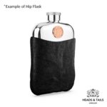 Pewter hip flask in a black leather sleeve at an angle, copper Australian coin set above the leather