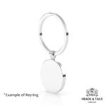 Blank back of a round silver bezel keyring on a split ring, plain white background