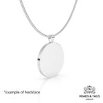 Back of a plain polished silver coin bezel pendant hanging from a silver snake chain, angled on white