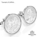 Close-up of silver cufflinks set with US quarters, eagle reverse and 1967 Washington head visible