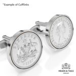 Close up of silver cufflinks set with 1957 Australian sixpences, kangaroo and emu coat of arms in detail