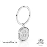 1957 Australian sixpence in a polished silver bezel keyring, angled side view showing the coat of arms