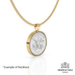 1957 Australian sixpence in a gold bezel on a gold snake chain, coat of arms design, angled view